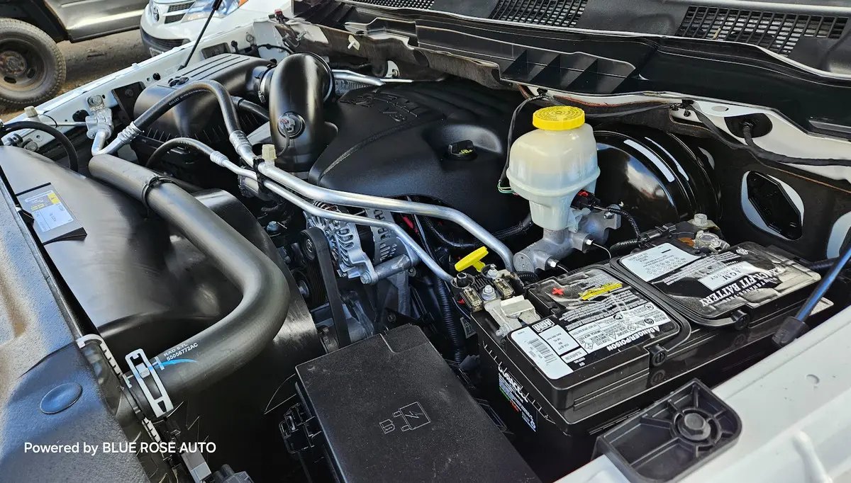 Technician working under the hood of a truck at the Blue Rose Auto shop on Olympic Street in Springfield, Oregon