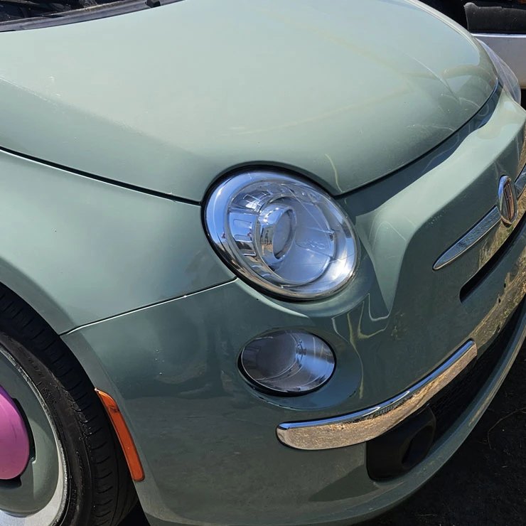 Fiat 500 in its original sage green factory paint before a vinyl color change wrap