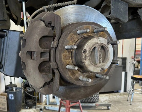 Front brake rotor, caliper and wheel hub on a Ford truck with the wheel removed