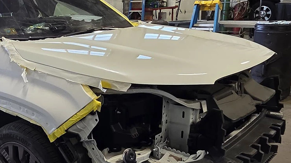 Front-end collision damage with the radiator support exposed at Blue Rose Auto in Springfield, Oregon