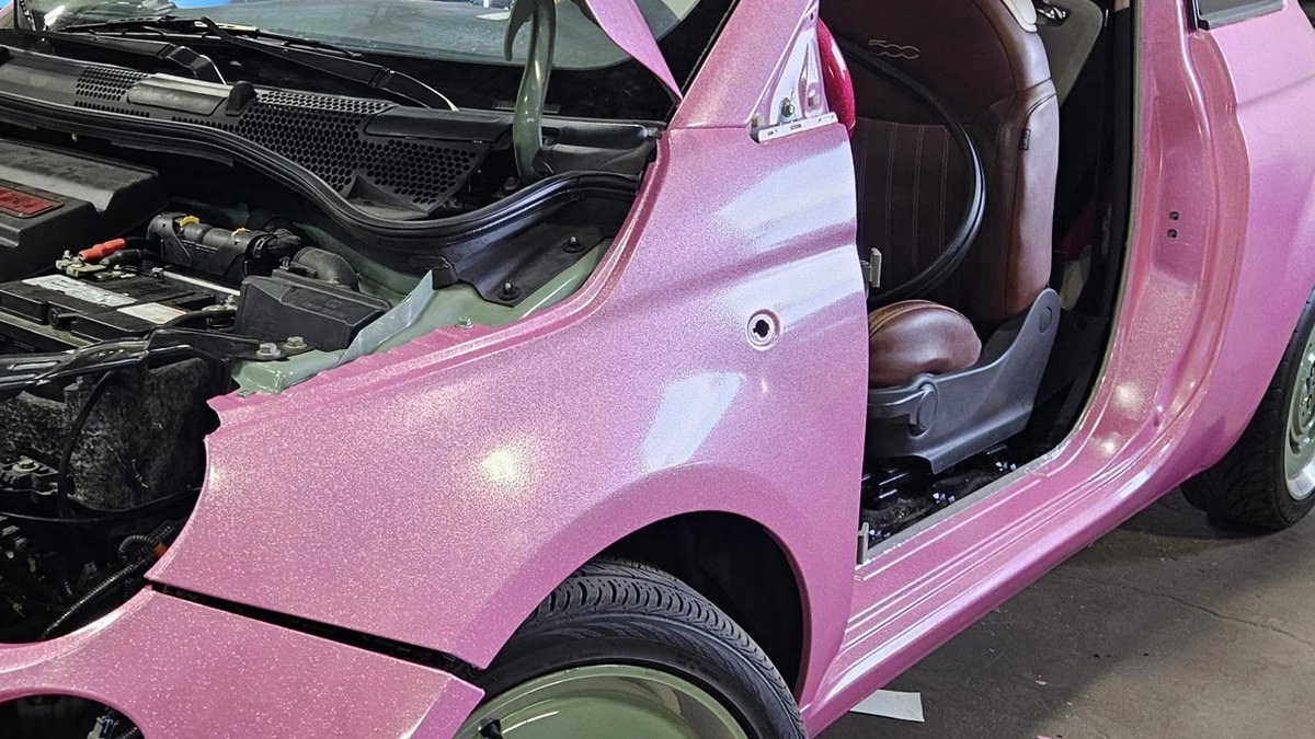 Pink glitter color-change vinyl wrap on a hatchback in the Blue Rose Auto shop in Springfield, OR