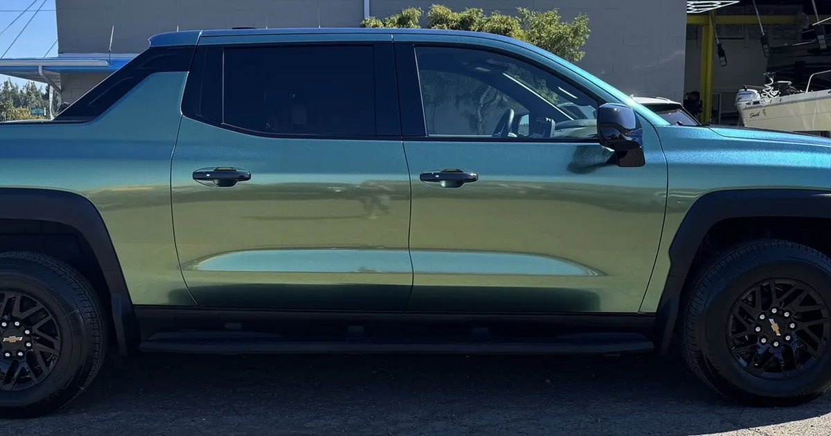 Chevy Silverado EV in teal color-shift vinyl wrap at Blue Rose Auto in Springfield, OR