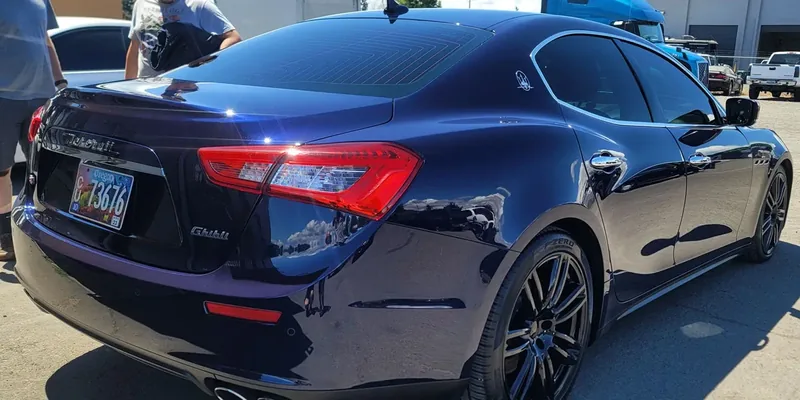 Navy Maserati Ghibli with tinted rear glass outside our Springfield shop